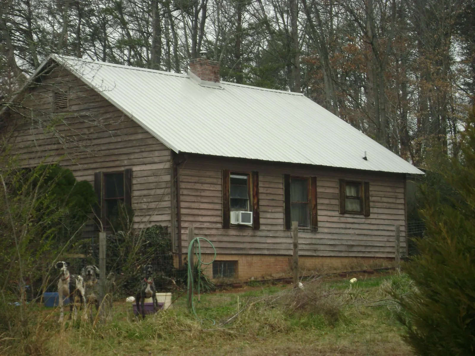 White metal roof on an old wood sided farmhouse, from a Metal Roof Installation job in White Earth